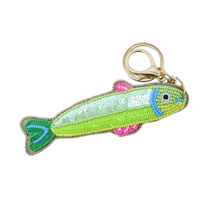 Fish-shaped keychain with colorful beading on a white surface